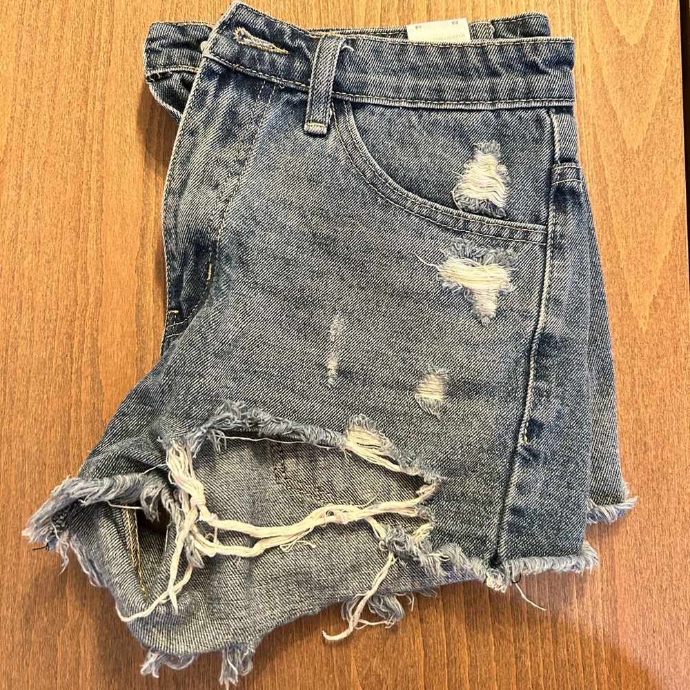 Women’s KanCan denim shirts with distressed/ripped detailing. Size small/26